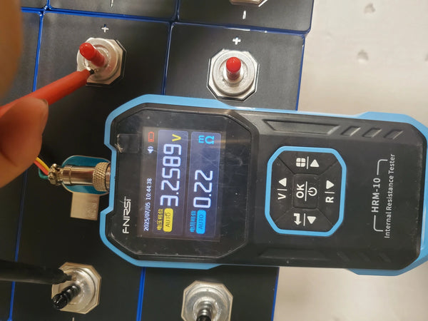 Real prismatic LiFePO4 cells being measured at the terminals with an internal-resistance tester